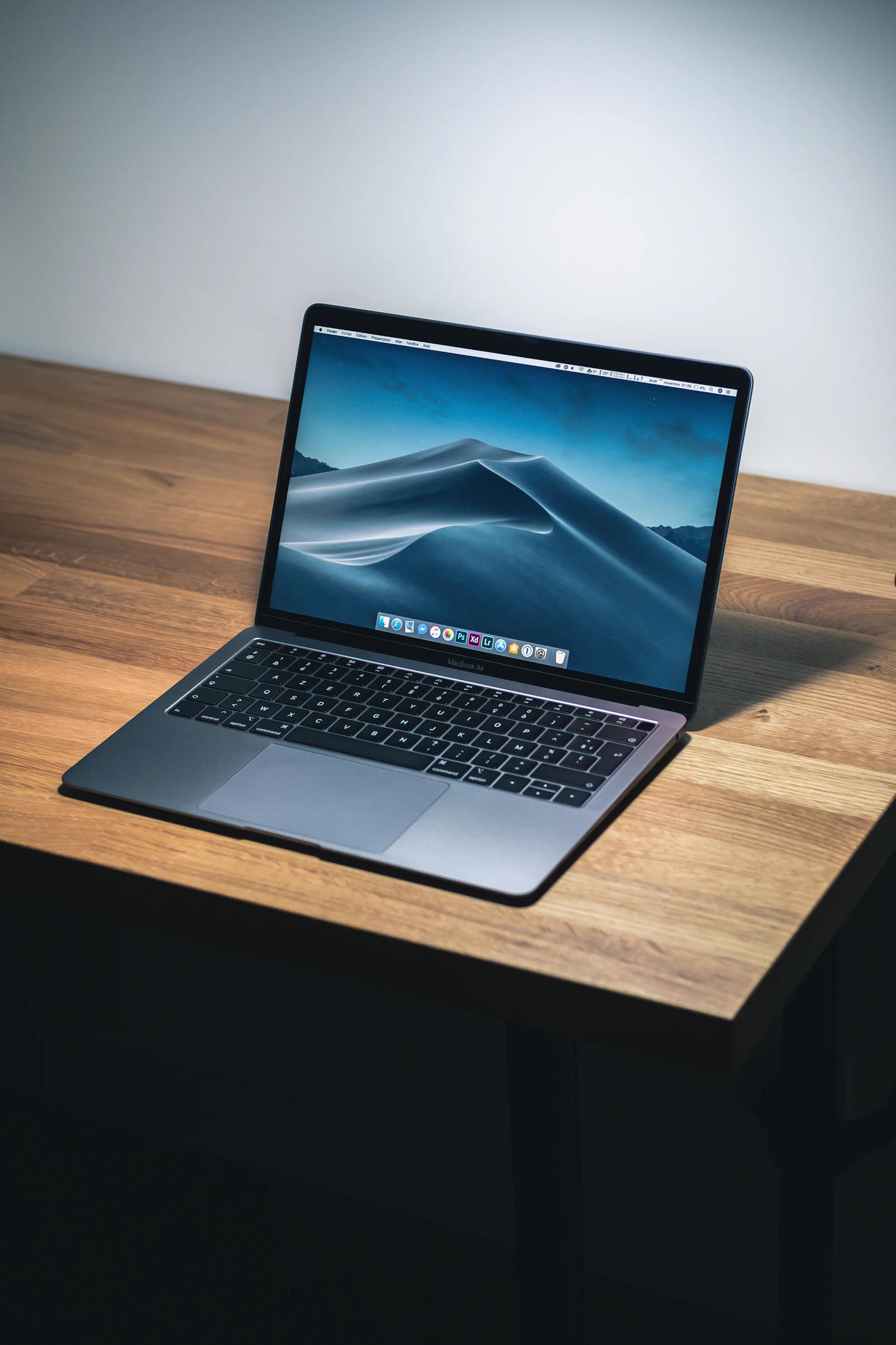 The MacBook Pro open on the desk it lived on
